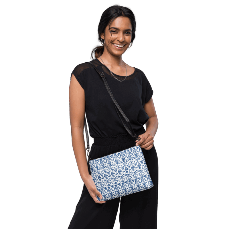 cross body bag. Model wearing cross body bag with floral blue print.